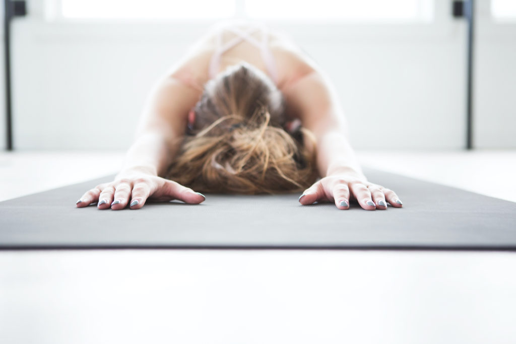 A woman doing yoga for health and wellness