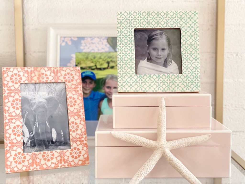 Three Picture frames with a starfish against pink boxes 