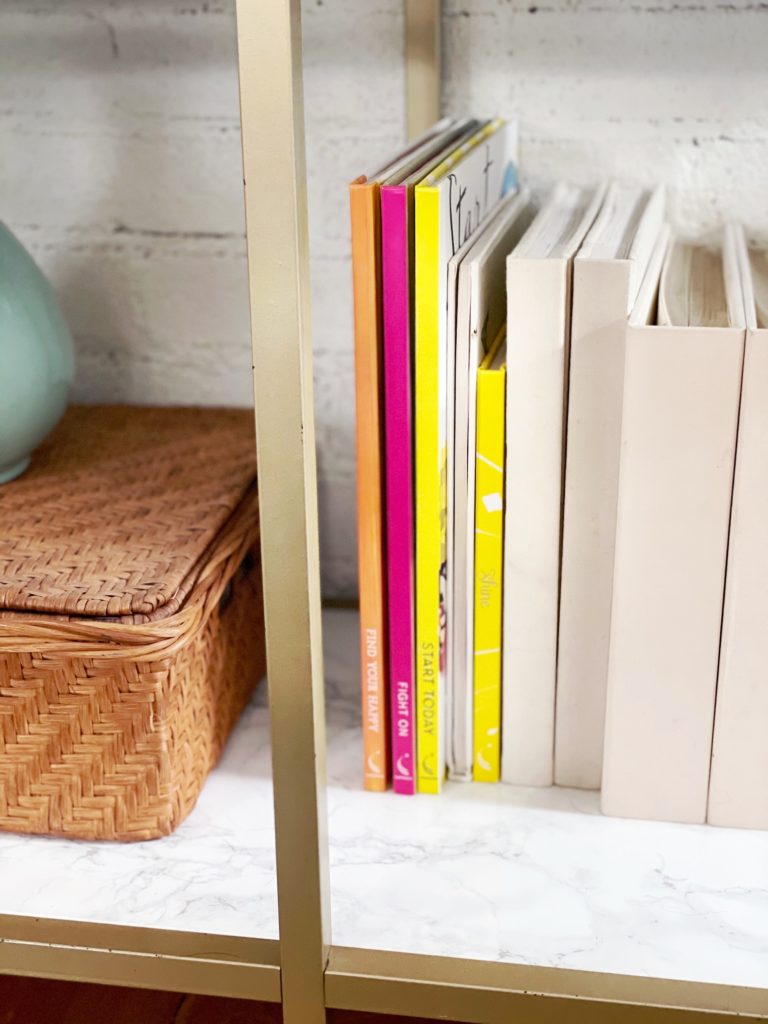 books and a natural basket on a marble surface on a Vittsjö bookcase hack