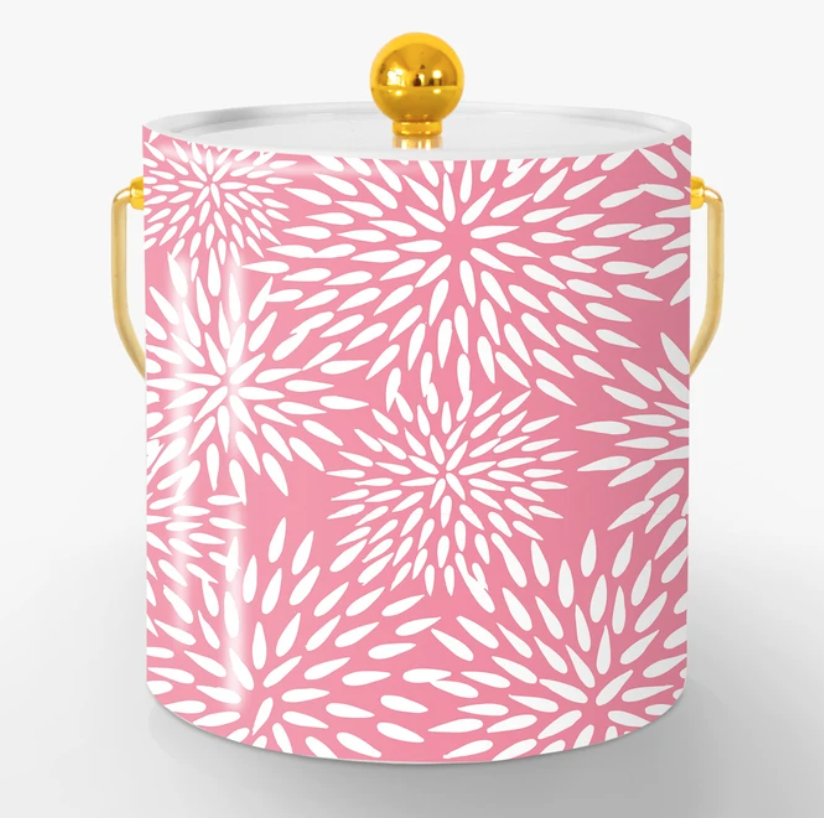 A pink Ice bucket with a gold handle and knob