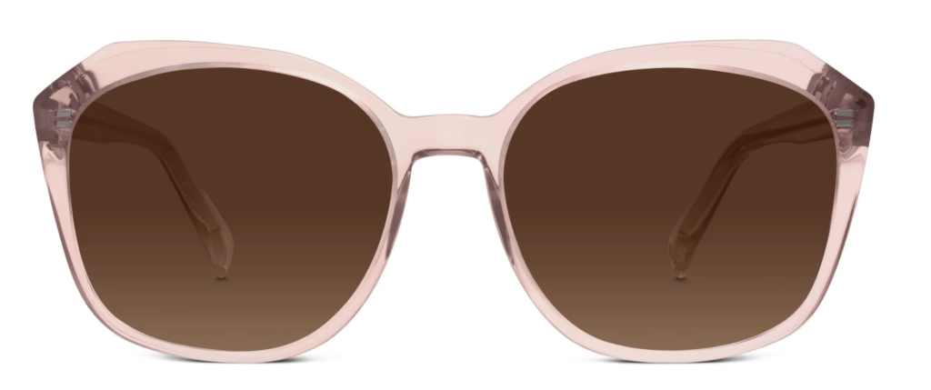 A pair of pink Warby Parker sunglasses with a round shape