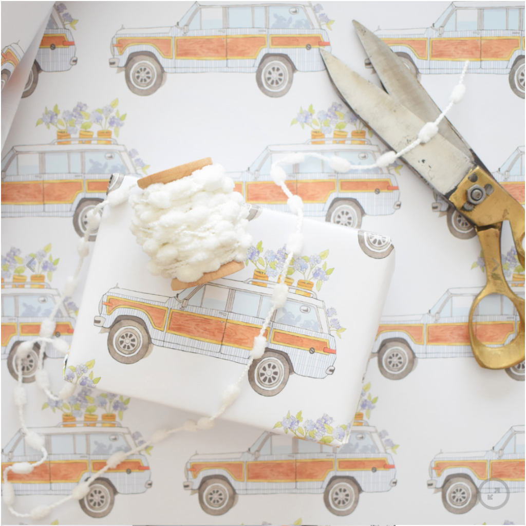 Wrapping paper with a woody with flowers, ribbon and an old pair of scissors